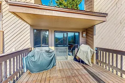 a porch with a cover on a house at Huntington Lake Condo #102 in Lakeshore