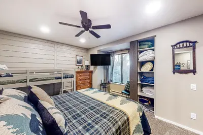 a bedroom with a bed and a ceiling fan at Huntington Lake Condo #102 in Lakeshore