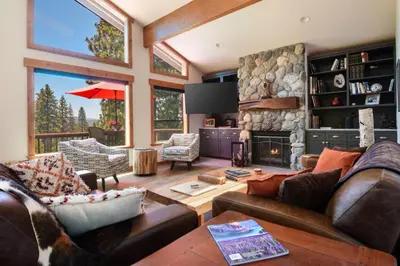 a living room with a couch and a fireplace at 17th Tee Lake Tahoe Retreat in Incline Village