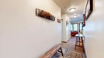 a hallway with a bench next to a wall at Eagle Run #114 condo in Mammoth Lakes