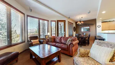 a living room with leather couches and a table at Eagle Run #114 condo in Mammoth Lakes