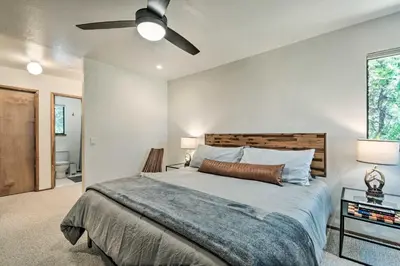 a bedroom with a bed and a ceiling fan at Hike, Fish, and Relax Family Arnold Cabin in Arnold