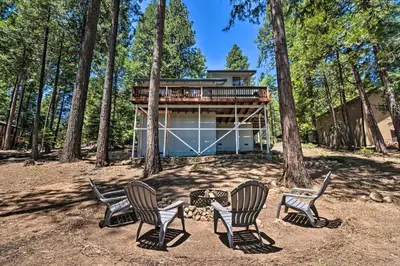 a group of chairs sitting in front of a house at Hike, Fish, and Relax Family Arnold Cabin in Arnold