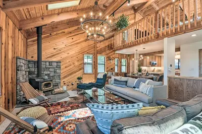 a living room with a couch and a fireplace at Hike, Fish, and Relax Family Arnold Cabin in Arnold
