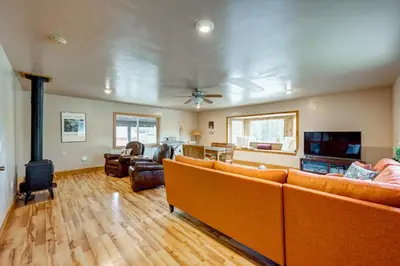 a living room with orange couches and a tv at Toast of the Mountain Town in Truckee