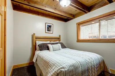 a bedroom with a bed and a window at Toast of the Mountain Town in Truckee