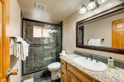 a bathroom with a sink and a toilet and a mirror at Toast of the Mountain Town in Truckee