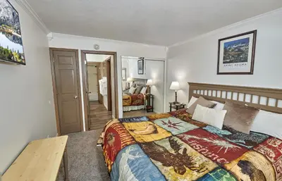 a bedroom with a bed and a table in it at St Anton Condos #49 condo in Mammoth Lakes