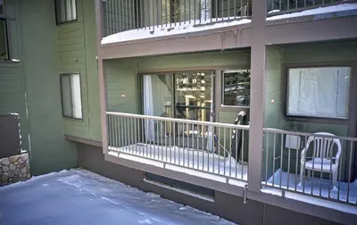 a balcony of a house with snow on the ground at St Anton Condos #49 condo in Mammoth Lakes