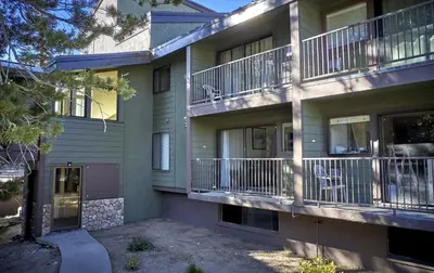 an apartment building with balconies and a driveway at St Anton Condos #49 condo in Mammoth Lakes