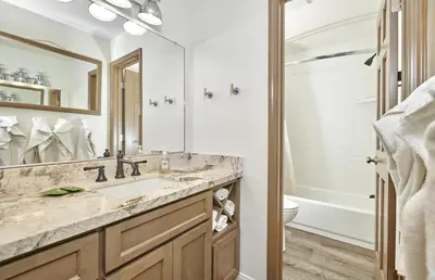 a bathroom with a sink and a toilet and a mirror at St Anton Condos #49 condo in Mammoth Lakes