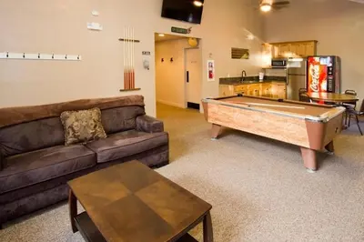 a living room with a couch and a pool table at St Anton Condos #77 condo in Mammoth Lakes