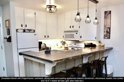 a kitchen with white cabinets and a wooden counter top at St Anton Condos #77 condo in Mammoth Lakes
