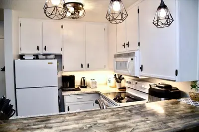a kitchen with white cabinets and a white refrigerator at St Anton Condos #77 condo in Mammoth Lakes