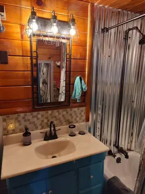a bathroom with a sink and a tub and a mirror at O'Brien's Oasis in Miramonte