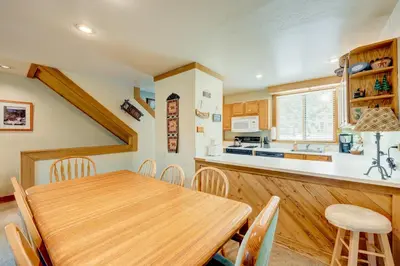 a kitchen and dining room with a wooden table and chairs at Pine Time in Truckee