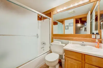 a bathroom with a toilet and a sink and a mirror at Pine Time in Truckee