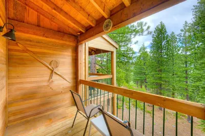 a screened porch with two chairs and a window at Pine Time in Truckee