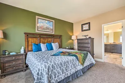 a bedroom with a large bed with blue pillows at Air Racing Decor, Hot Tub Sparks Home! in Sparks