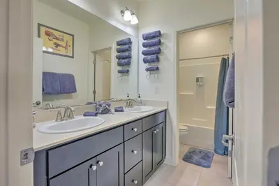 a bathroom with two sinks and a mirror and a tub at Air Racing Decor, Hot Tub Sparks Home! in Sparks