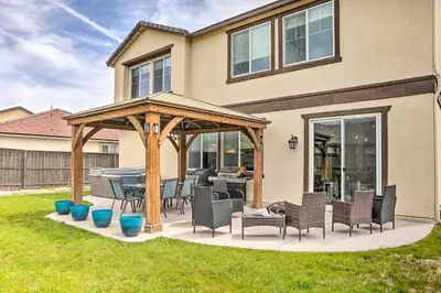 a gazebo with chairs and a table in a yard at Air Racing Decor, Hot Tub Sparks Home! in Sparks