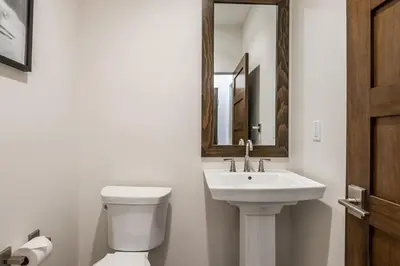a bathroom with a sink and a toilet and a mirror at Creekhouse 1334 in Mammoth Lakes