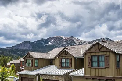 a house with a mountain in the background at Creekhouse 1334 in Mammoth Lakes