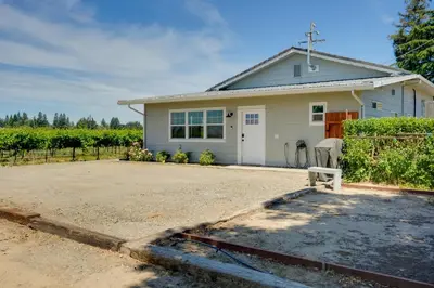a white house with a driveway in front of it at Charming Lodi Retreat Walk to Local Wineries in Lodi