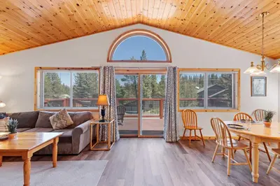 a living room with a couch and a table at Less Than 8 Mi to Donner Lake Home with Deck and Balcony! in Truckee