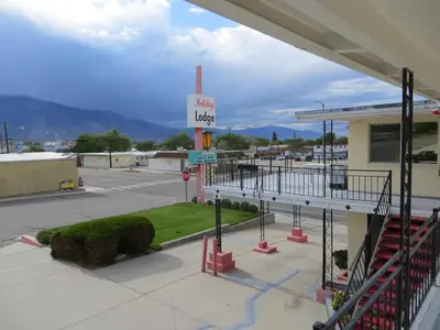 a gas station with a sign in a parking lot at Holiday Lodge in Hawthorne
