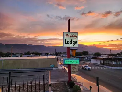 a sign for a library lodge on the side of a road at Holiday Lodge in Hawthorne