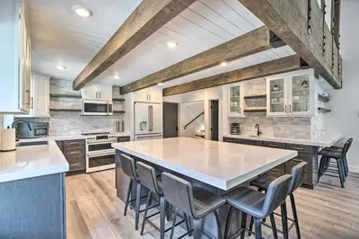 a kitchen with a large island with chairs in it at Luxe Mountain Home in Village, Steps to Gondola! in Mammoth Lakes
