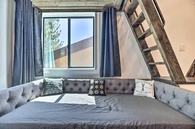 a couch in a room with a window at Luxe Mountain Home in Village, Steps to Gondola! in Mammoth Lakes