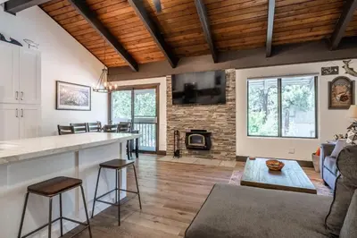 a kitchen and living room with a bar and a fireplace at Horizons IV #156 New Luxurious Listing! Fully Remodeled 2 Bedroom Plus Loft 3 Full Bathroom Sleeps 8 in Mammoth Lakes