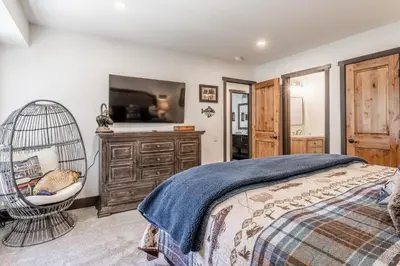 a bedroom with a bed and a swing at Horizons IV #156 New Luxurious Listing! Fully Remodeled 2 Bedroom Plus Loft 3 Full Bathroom Sleeps 8 in Mammoth Lakes