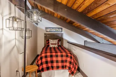 a bedroom with a bed with a plaid blanket at Horizons IV #156 New Luxurious Listing! Fully Remodeled 2 Bedroom Plus Loft 3 Full Bathroom Sleeps 8 in Mammoth Lakes