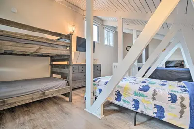 a bedroom with two bunk beds and a ladder at Elegant Mountain-View Condo Less Than 1 Mi to Lifts! in Mammoth Lakes