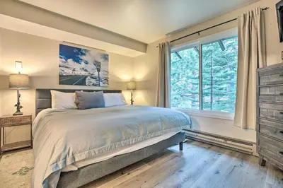 a bedroom with a bed and a large window at Elegant Mountain-View Condo Less Than 1 Mi to Lifts! in Mammoth Lakes