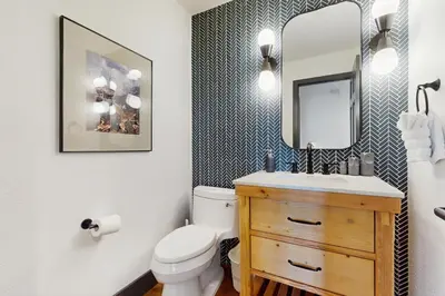 a bathroom with a toilet and a sink and a mirror at Bennett Flat Adventure in Truckee