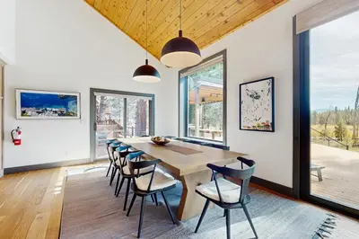a dining room with a wooden table and chairs at Bennett Flat Adventure in Truckee