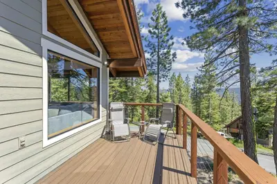 a wooden deck with two chairs and a table on it at Amazing Views - Modern Home - SH #14 in Bear Valley