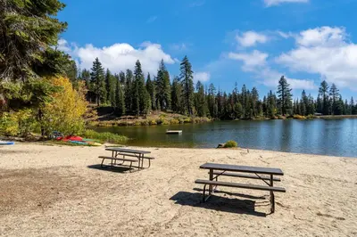 two picnic tables on a beach next to a lake at Amazing Views - Modern Home - SH #14 in Bear Valley