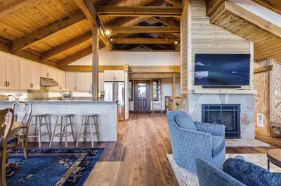 a kitchen and living room with a fireplace and a tv at Amazing Views - Modern Home - SH #14 in Bear Valley