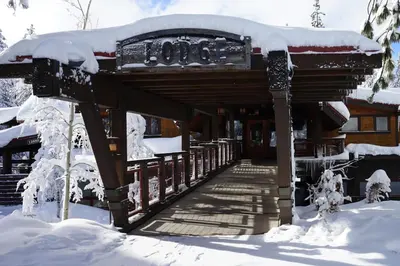 a building covered in snow with a snow covered roof at Falcon Point Pines in Truckee