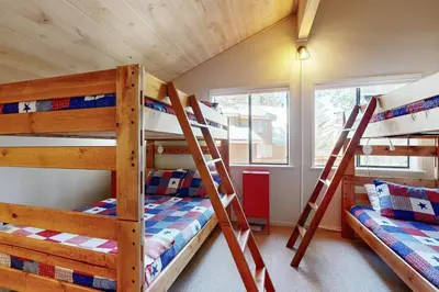 a bunk bed room with three bunk beds in a house at Falcon Point Pines in Truckee
