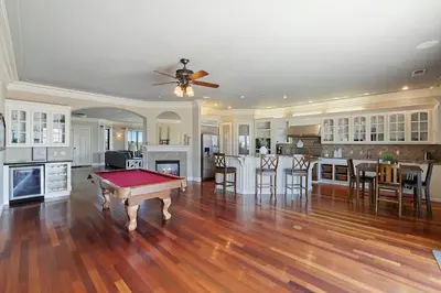 a living room with a pool table and a kitchen at 4BR LUXURY ENTERTAINMENT OASIS in Tracy