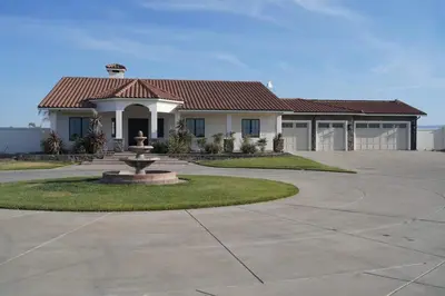 a house with a fountain in the middle of a driveway at 4BR LUXURY ENTERTAINMENT OASIS in Tracy