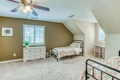 a bedroom with two beds and a ceiling fan at Wooded Bliss in Mariposa