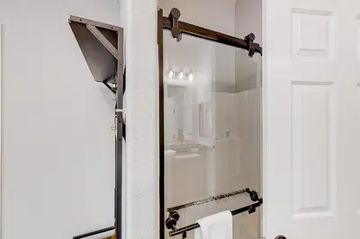 a shower with a glass door in a bathroom at Out in the Wild in Oakhurst