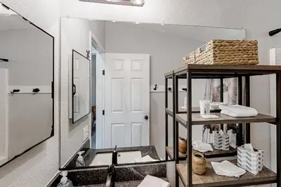 a bathroom with a sink and a mirror at Out in the Wild in Oakhurst